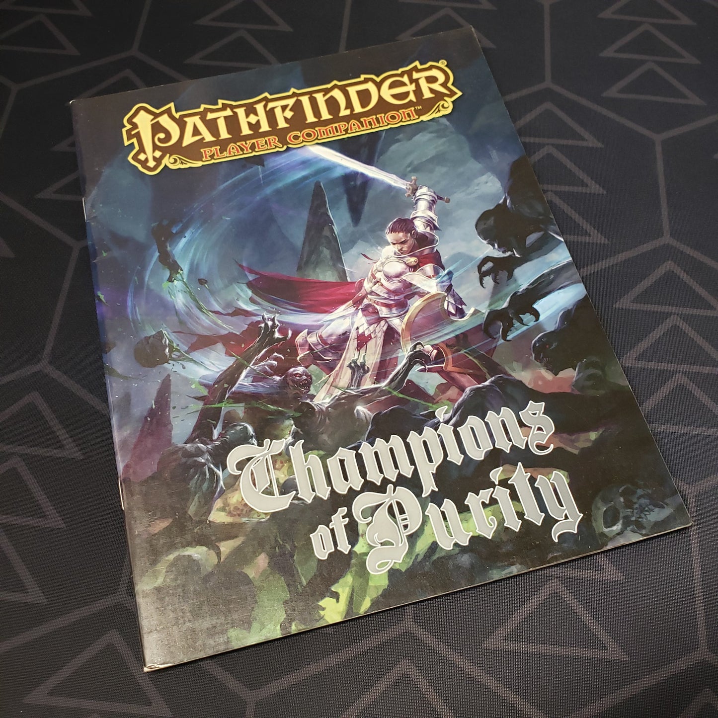 Image shows the front cover of the Champions of Purity book for the roleplaying game Pathfinder: First Edition