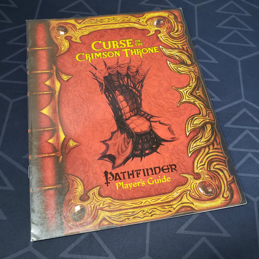 Image shows the front cover of the Curse of the Crimson Throne Player's Guide book for the roleplaying game Pathfinder: First Edition