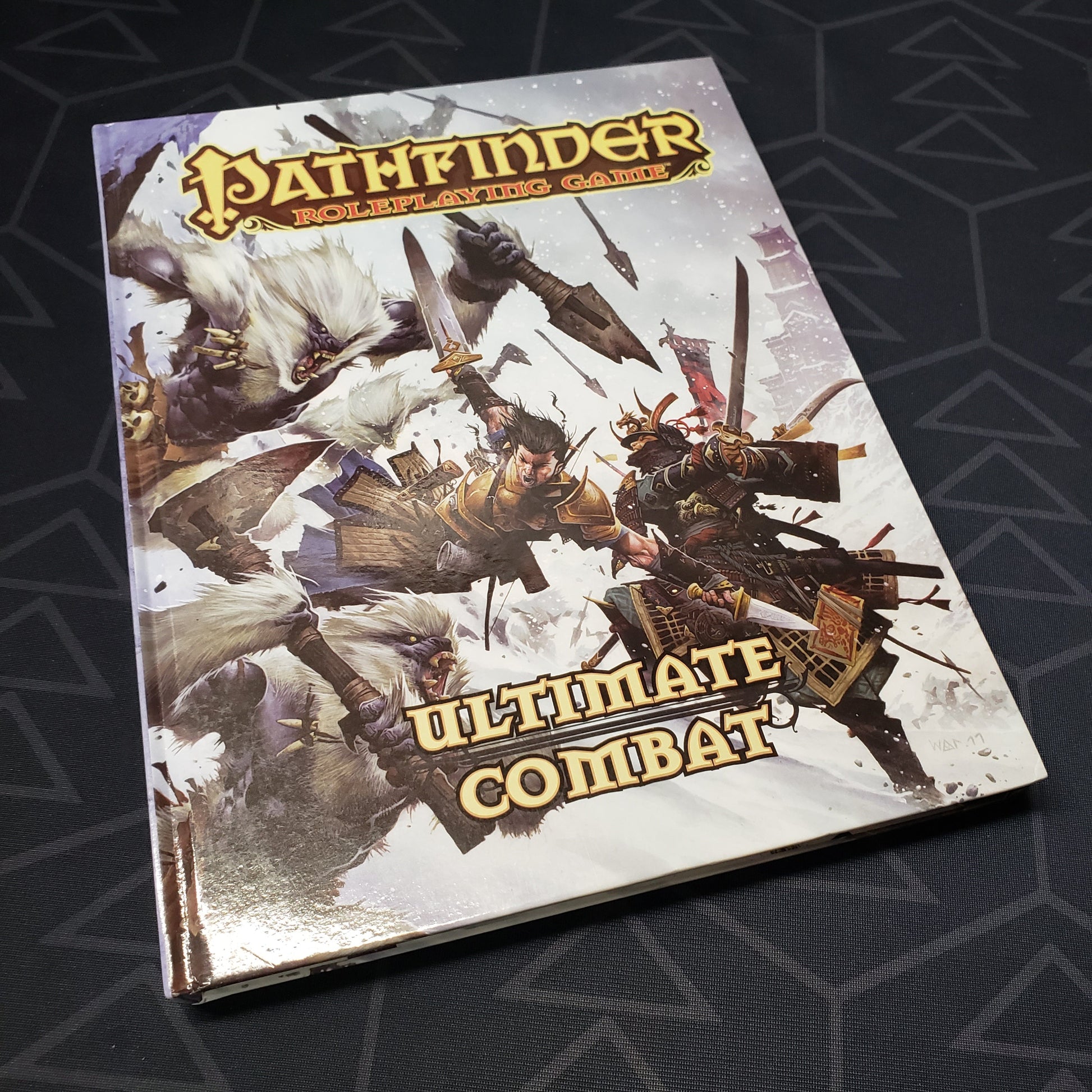 Image shows the front cover of the Ultimate Combat book for the roleplaying game Pathfinder: First Edition