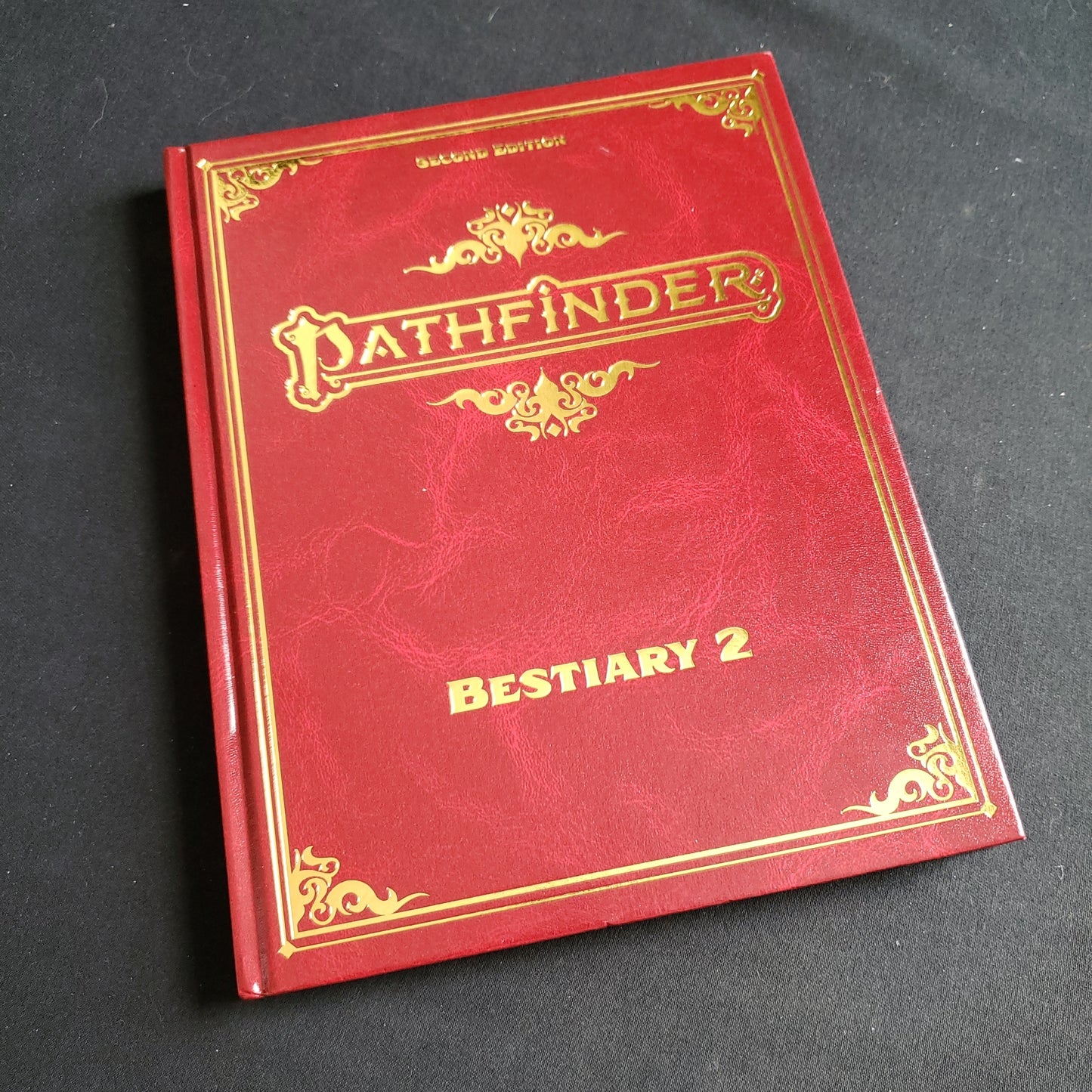 Image shows the front cover of the special edition Bestiary 2 book for the Pathfinder Second Edition roleplaying game