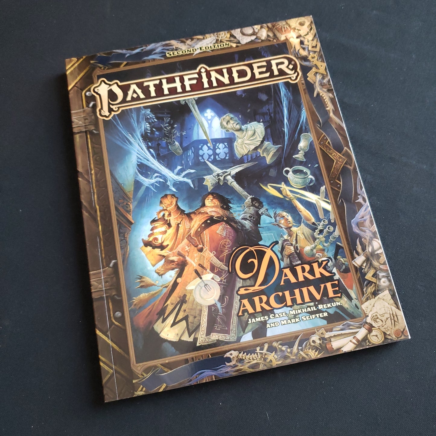 Image shows the front cover of the Dark Archive book for the Pathfinder 2E roleplaying game
