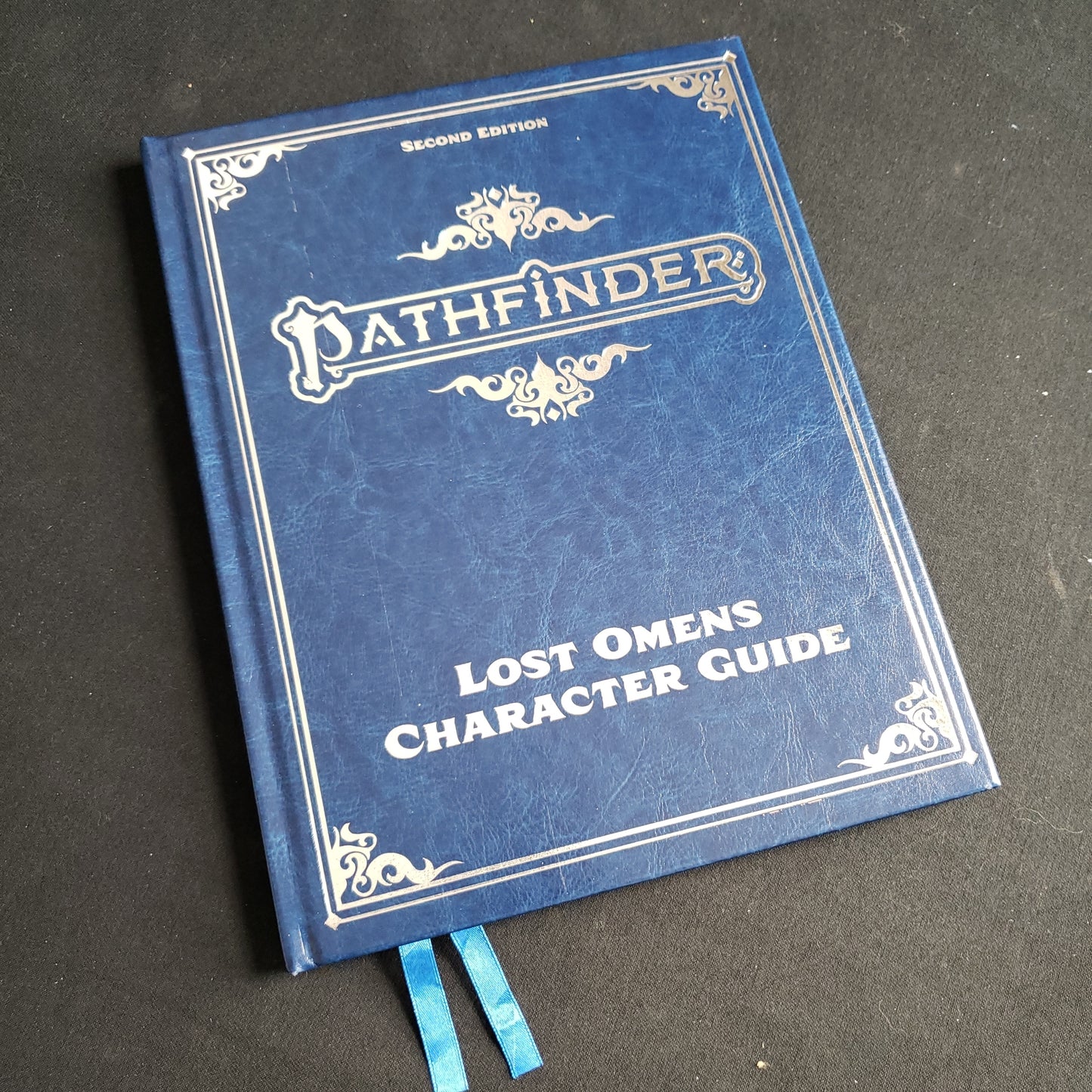 Image shows the front cover of the special edition Lost Omens: Character Guide book for the Pathfinder Second Edition roleplaying game