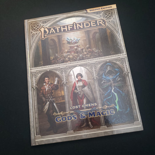 Image shows the front cover of the Lost Omens: Gods & Magic book for the Pathfinder 2E roleplaying game