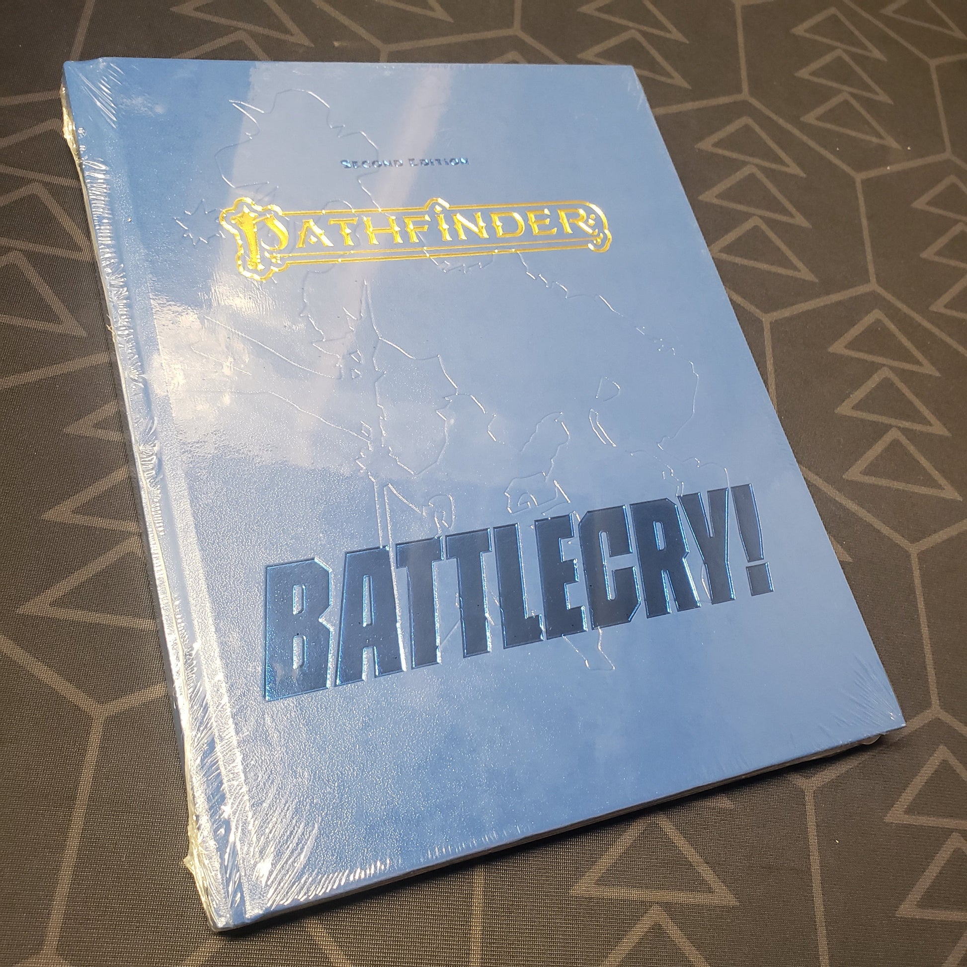 Image shows the front cover of the special edition of the Battlecry! book for the roleplaying game Pathfinder 2E