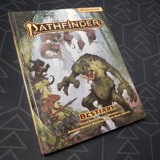 Image shows the front cover of the Bestiary book for the roleplaying game Pathfinder 2E