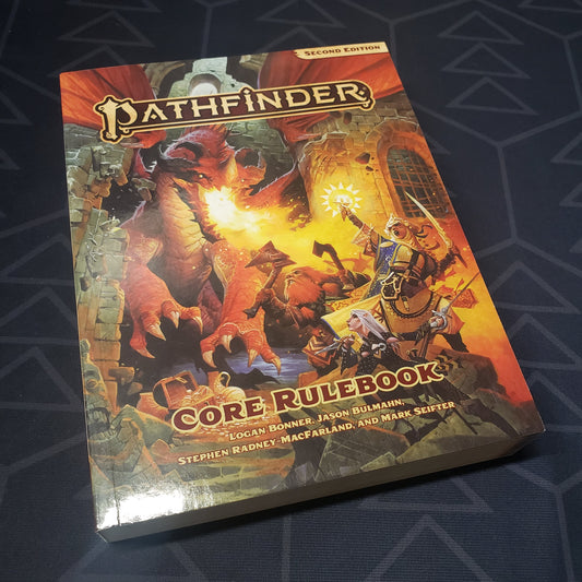 Image shows the front cover of the pocket edition core rulebook for the roleplaying game Pathfinder 2E