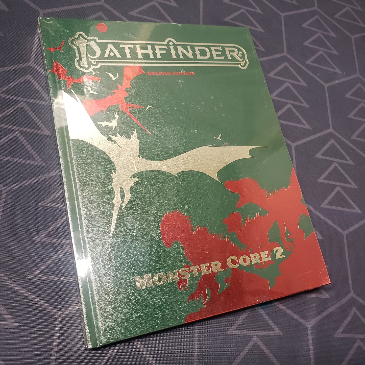 Image shows the front cover of the special edition of the Monster Core 2 book for the roleplaying game Pathfinder 2E