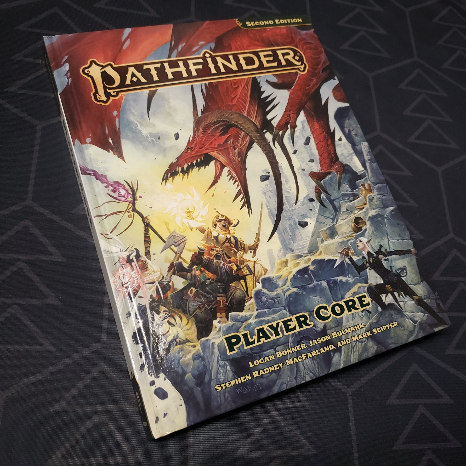 Image shows the front cover of the Player Core book for the roleplaying game Pathfinder 2E