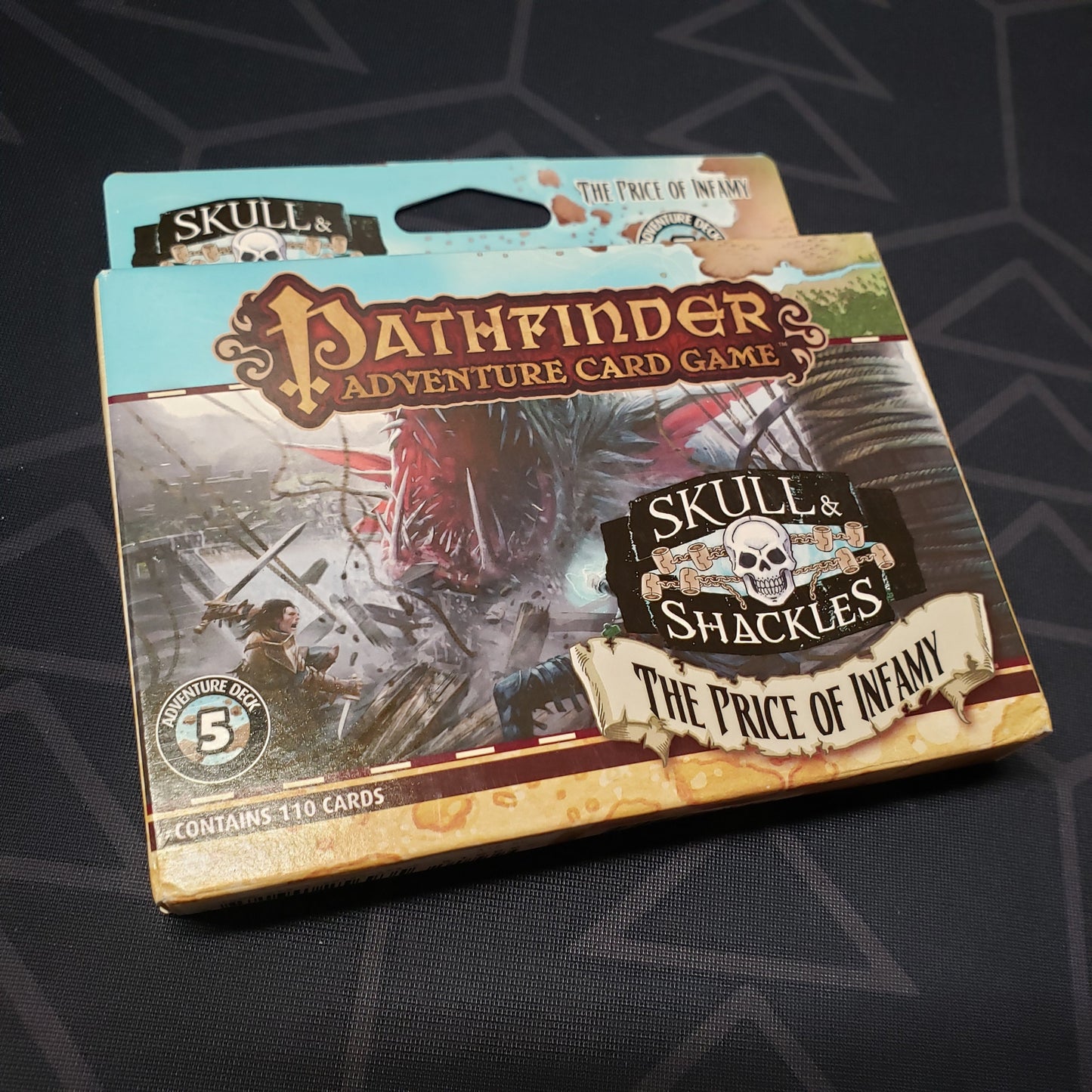 Image shows the front cover of the box of the Skull & Shackles Deck #5: The Price of Infamy expansion for the Pathfinder Adventure Card Game