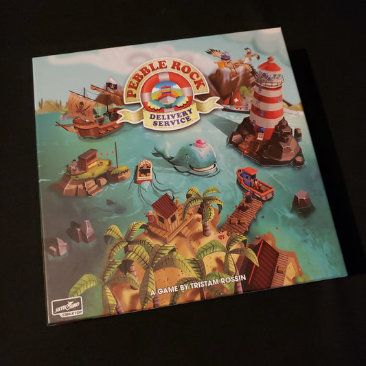 Image shows the front cover of the box of the Pebble Rock Delivery Service board game