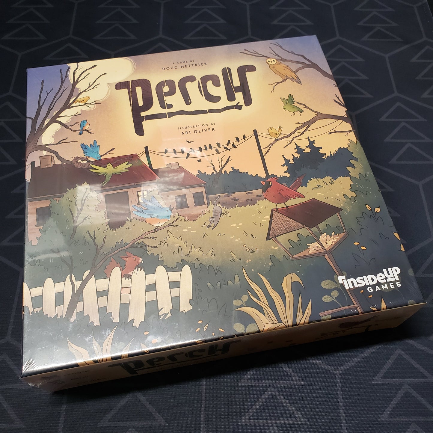 Image shows the front cover of the box for the Perch board game