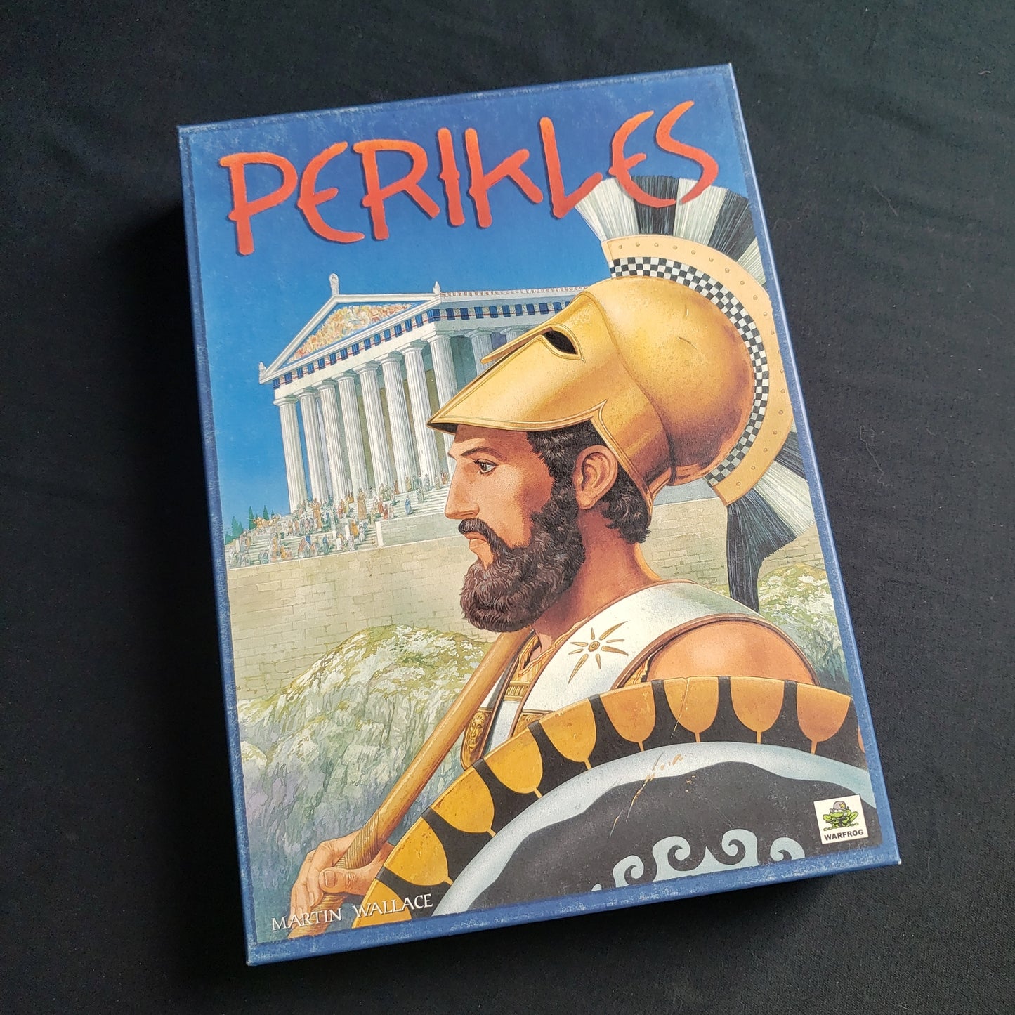 Image shows the front cover of the box of the Perikles board game