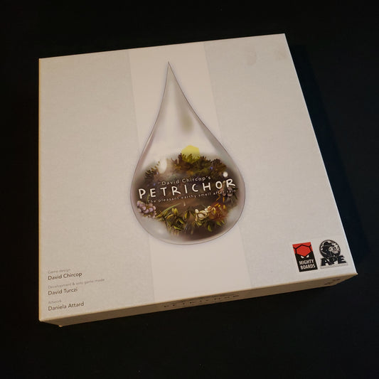 Image shows the front cover of the box of the Petrichor board game