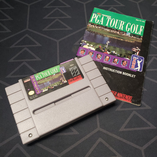 Image shows the front of the cartridge  & the manual for the video game PGA Tour Golf for the Super Nintendo