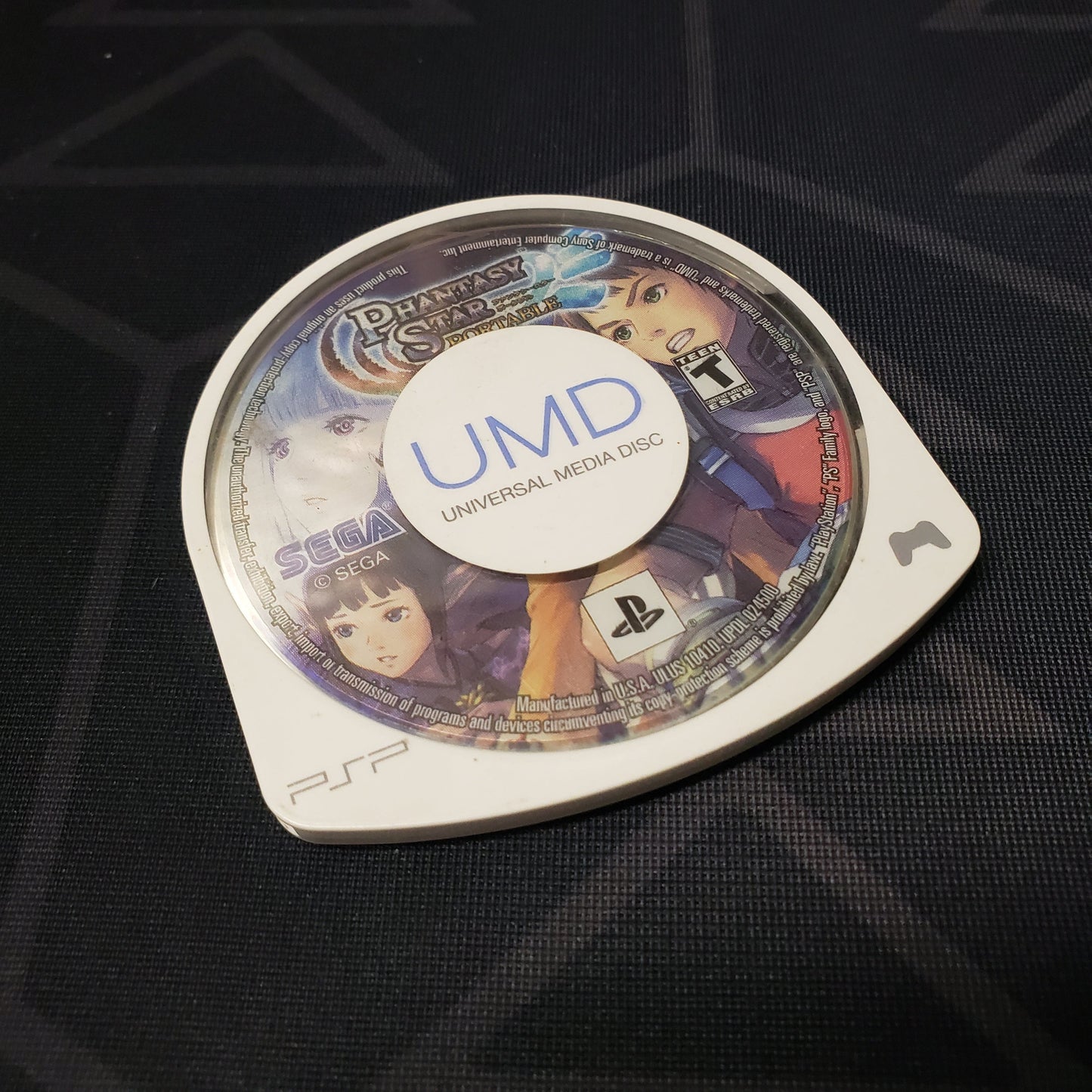 Image shows the label side of the UMD game disc for the video game Phantasy Star Portable for Playstation Portable