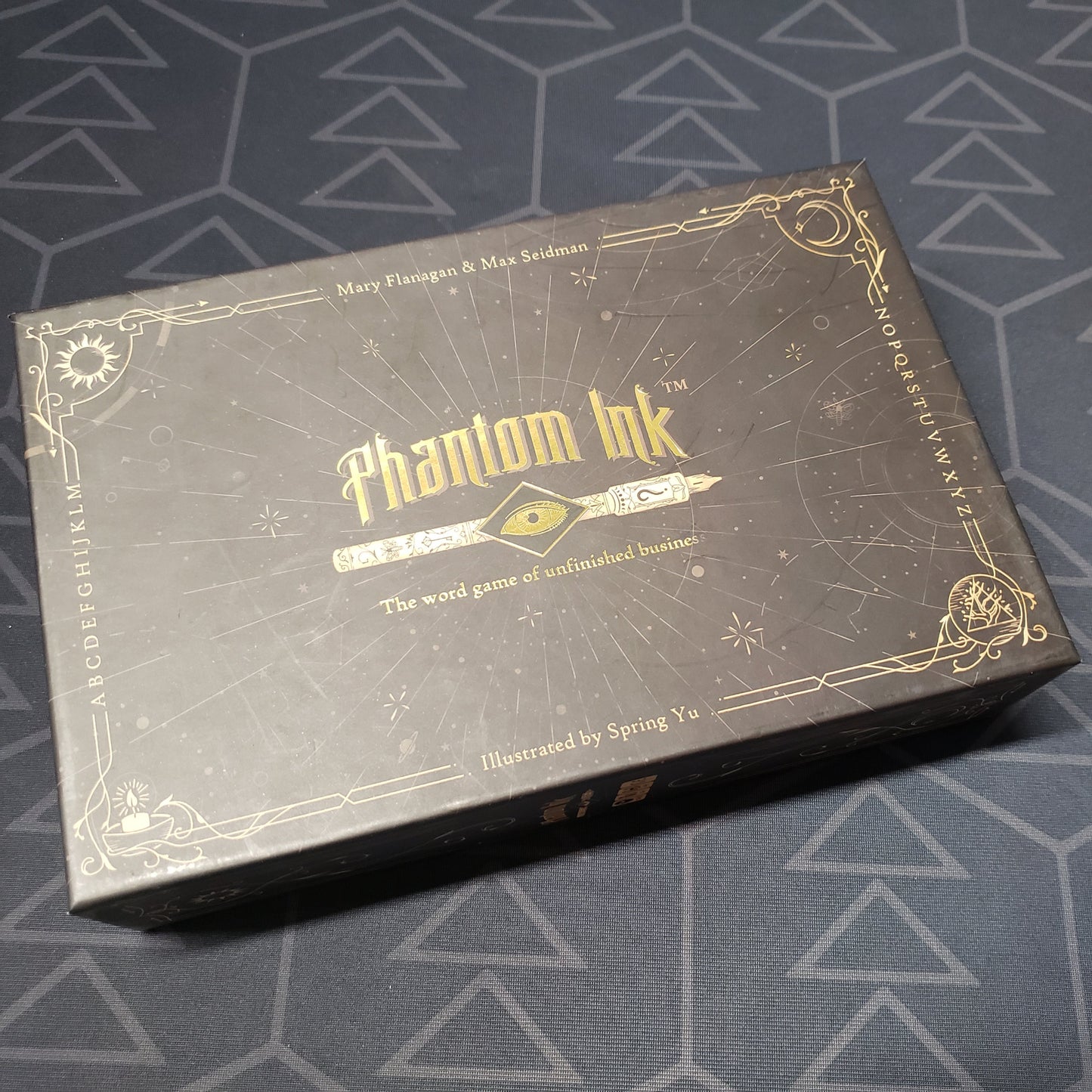 Image shows the front cover of the box for the Phantom Ink board game