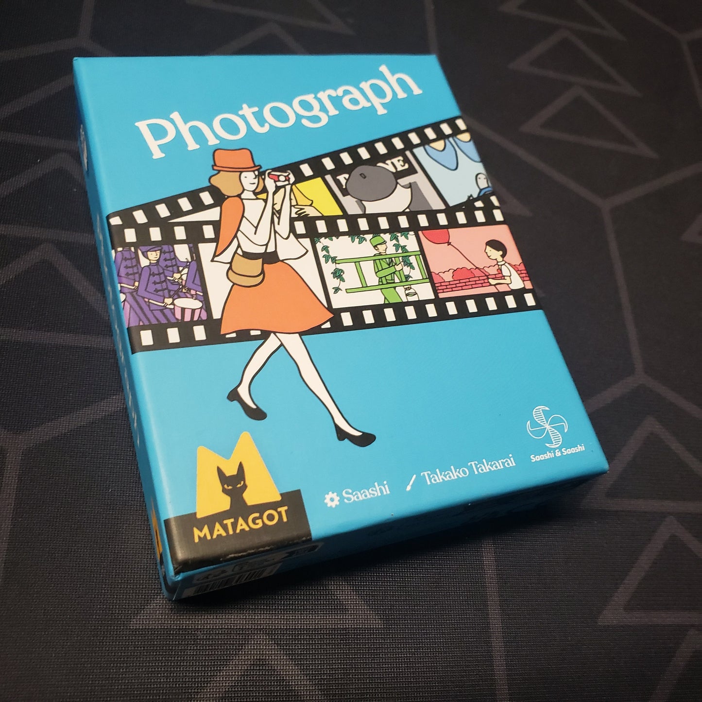 Image shows the front cover of the box for the Photograph card game