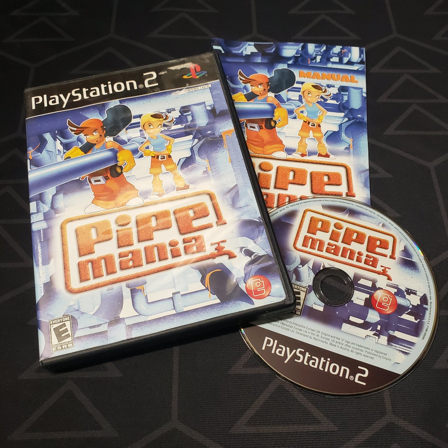 Image shows the case, manual and disc for the video game Pipe Mania for Playstation 2