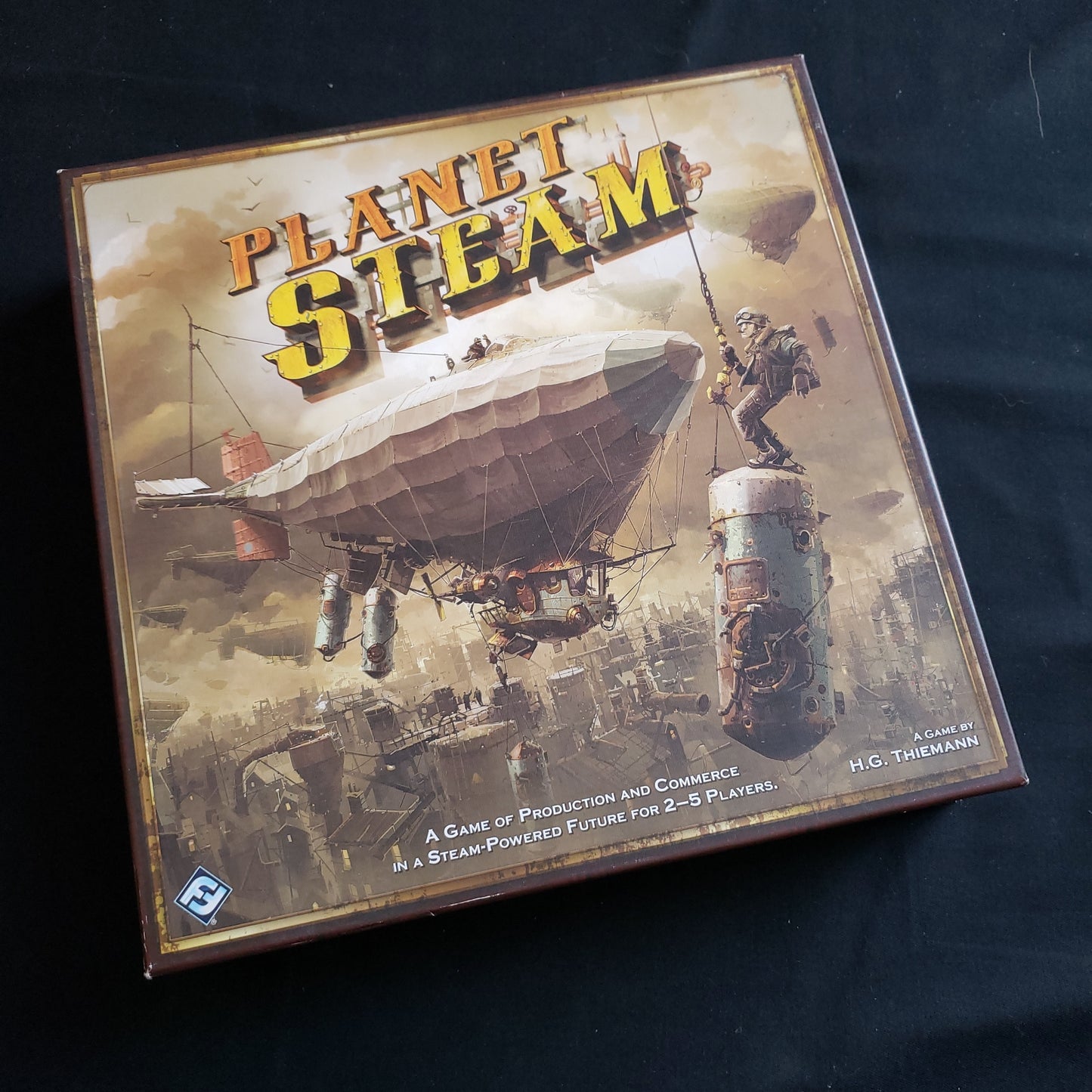 Image shows the front cover of the box of the Planet Steam board game