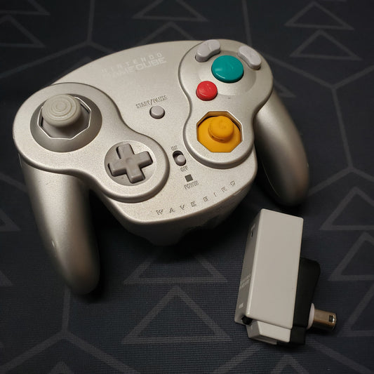 Image shows a Platinum Wavebird Wireless gaming controller for the Nintendo Gamecube