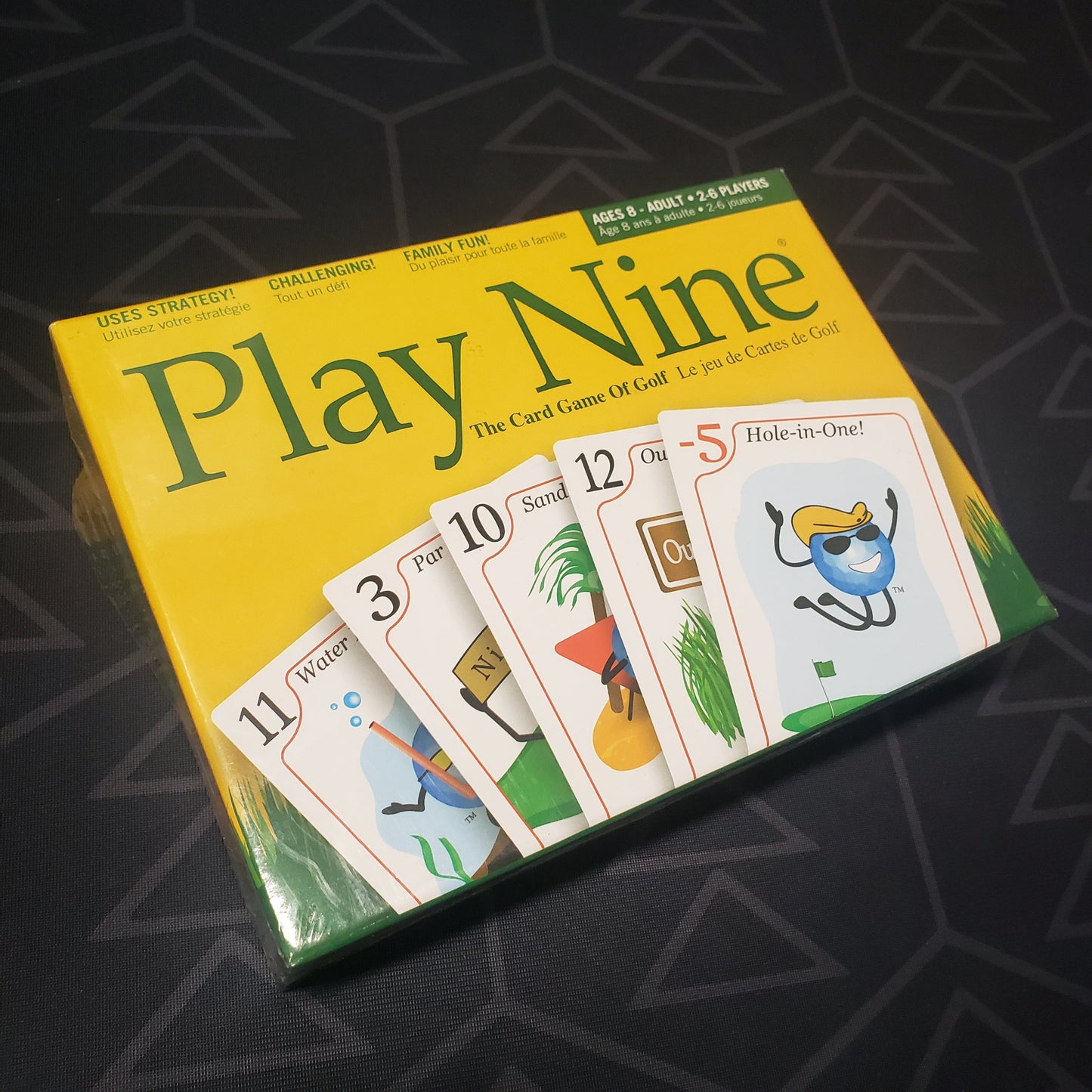 Image shows the front cover of the box for the Play Nine card game