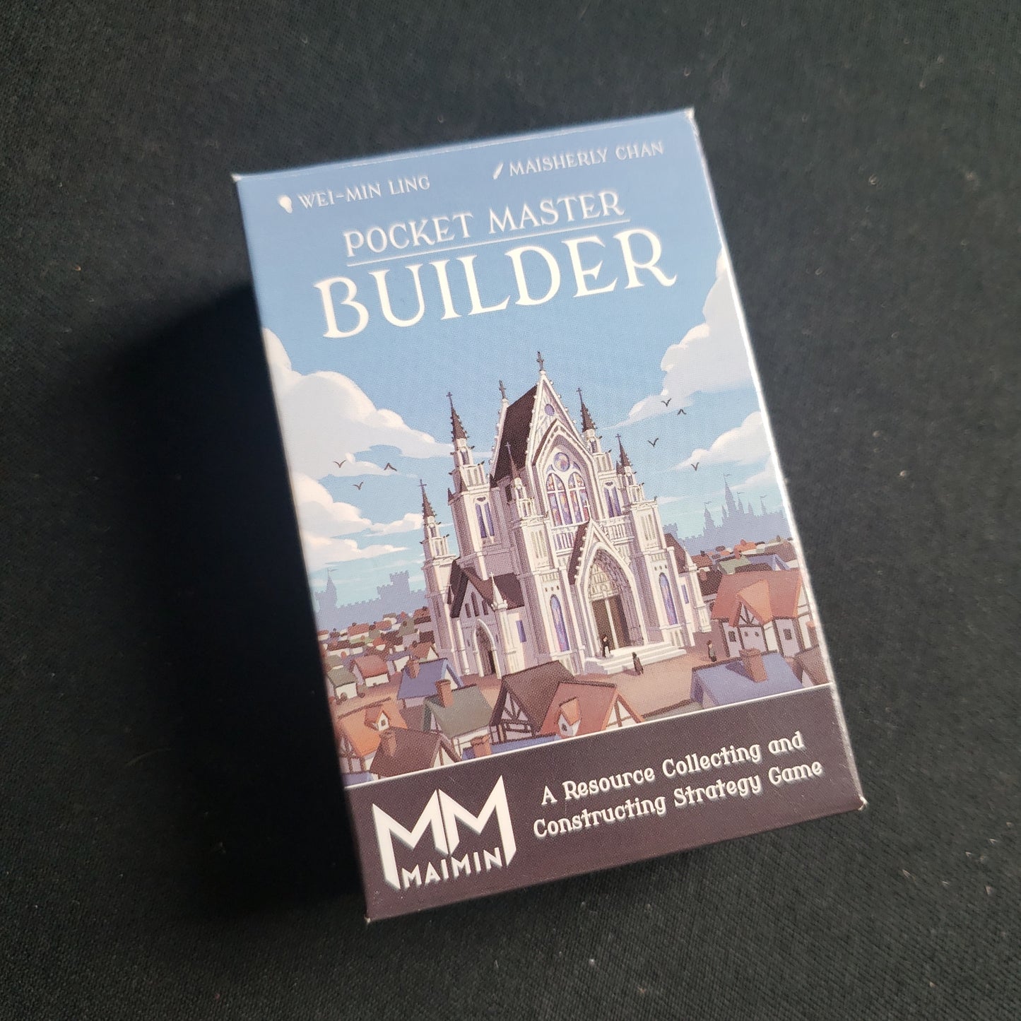 Image shows the front cover of the box of the Pocket Master Builder card game