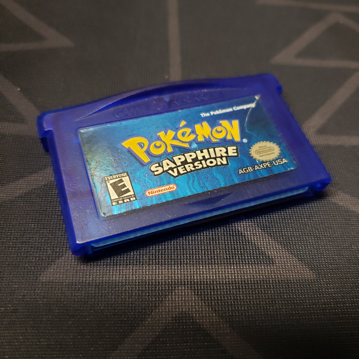 Image shows the front of the cartridge for the video game Pokemon Sapphire for Nintendo Game Boy Advance