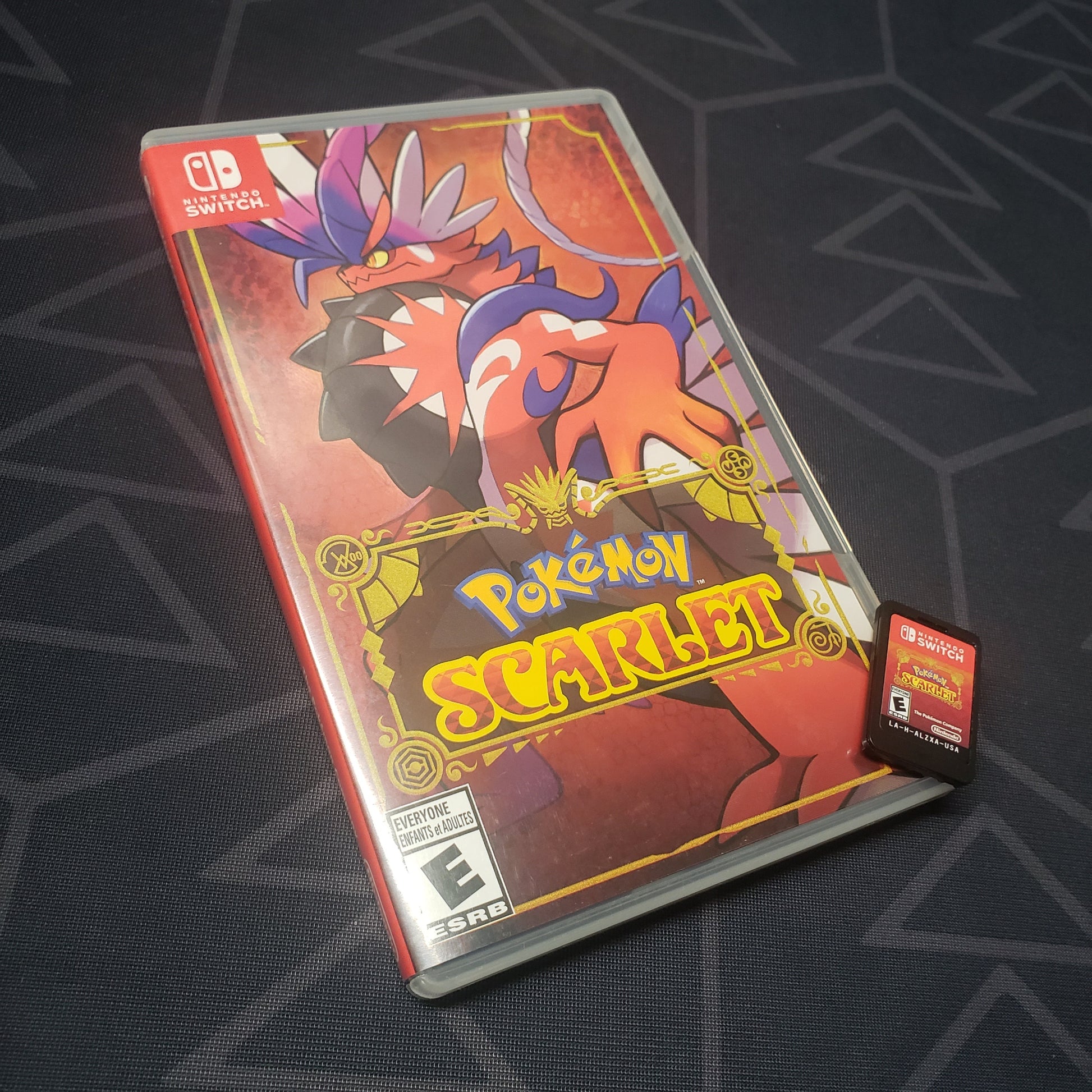 Image shows the case and cartridge for the video game Pokemon Scarlet for Nintendo Switch