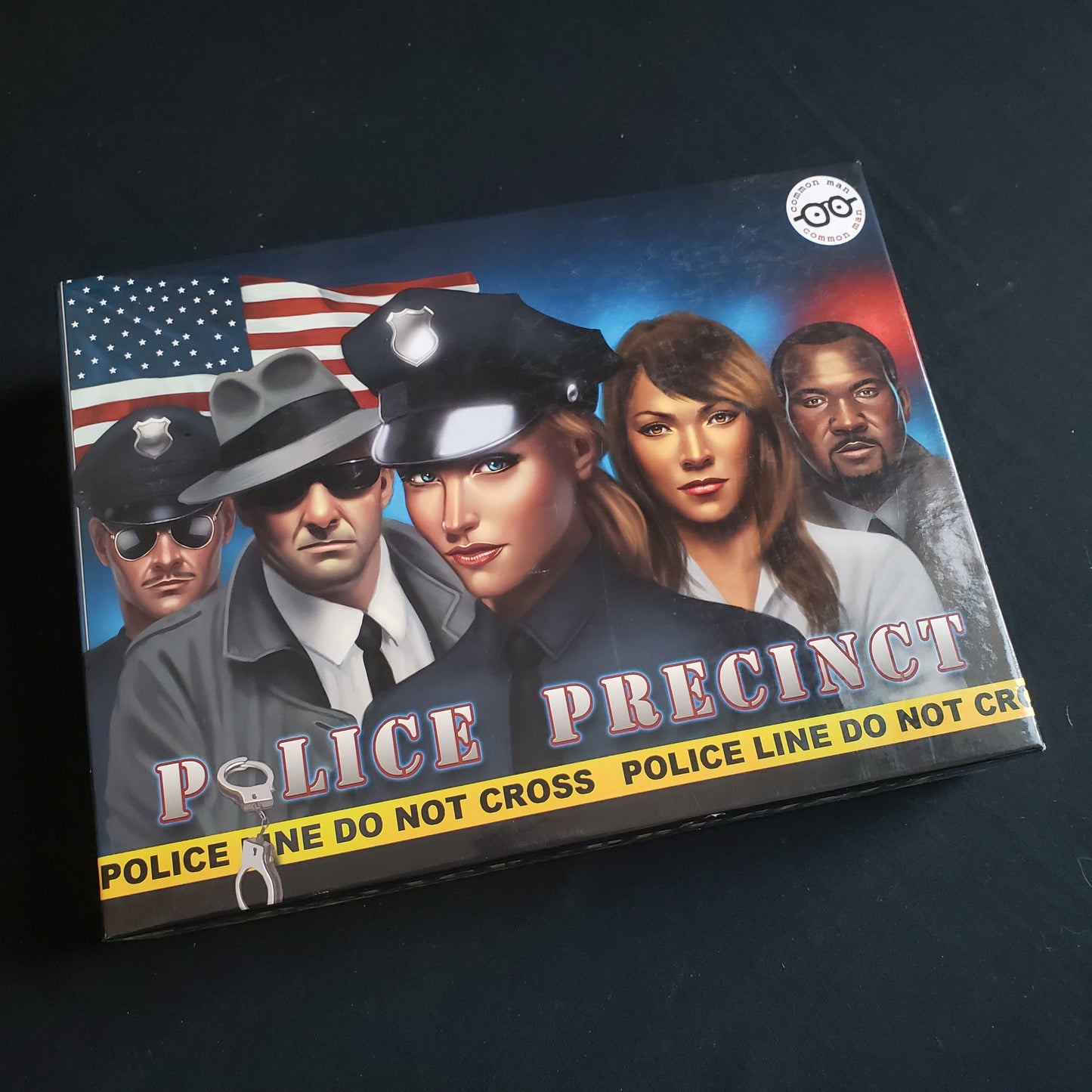 Image shows the front cover of the box of the Police Precinct board game