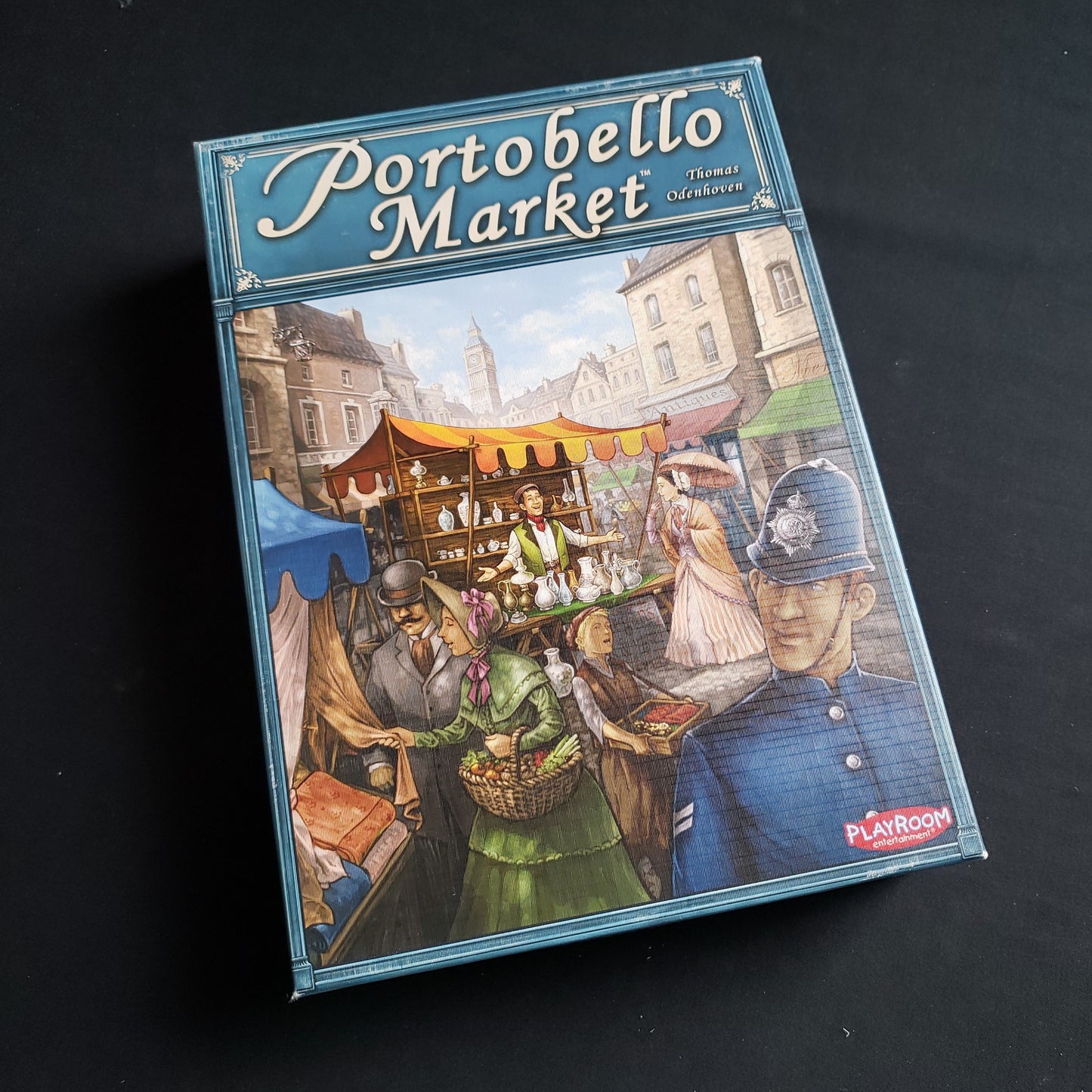 Image shows the front cover of the box of the Portobello Market board game