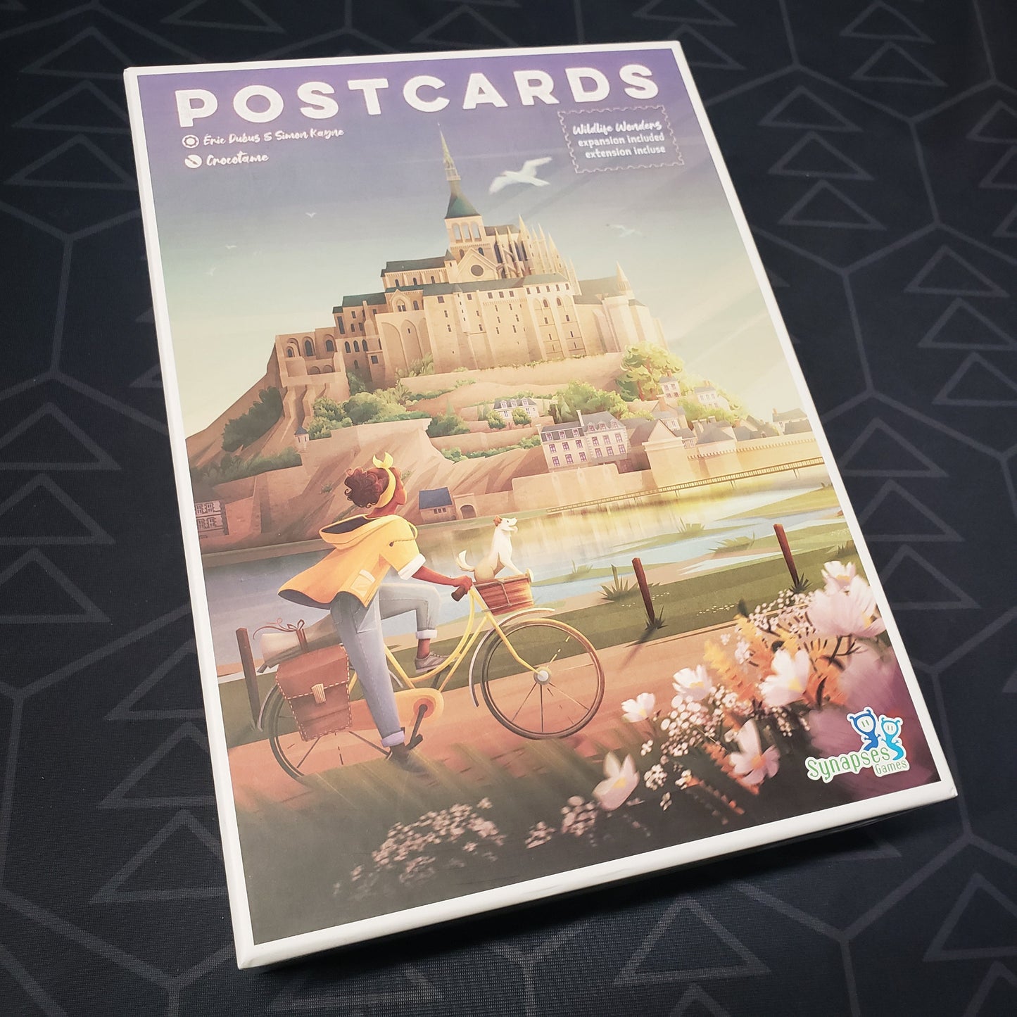 Image shows the front cover of the box for the Postcards board game