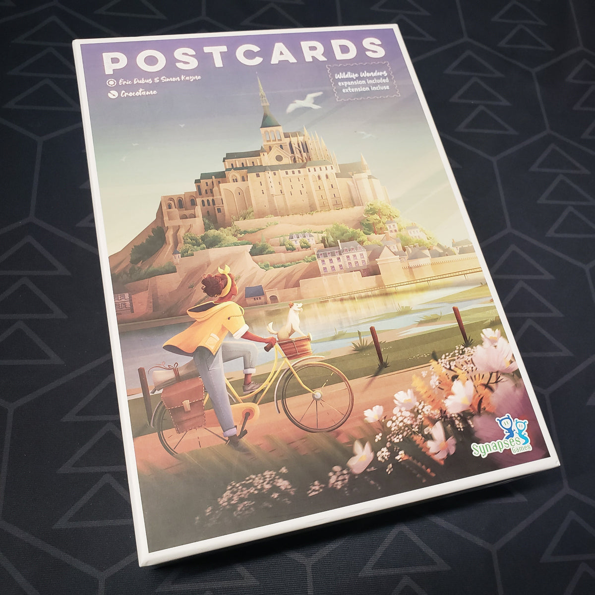Image shows the front cover of the box for the Postcards board game