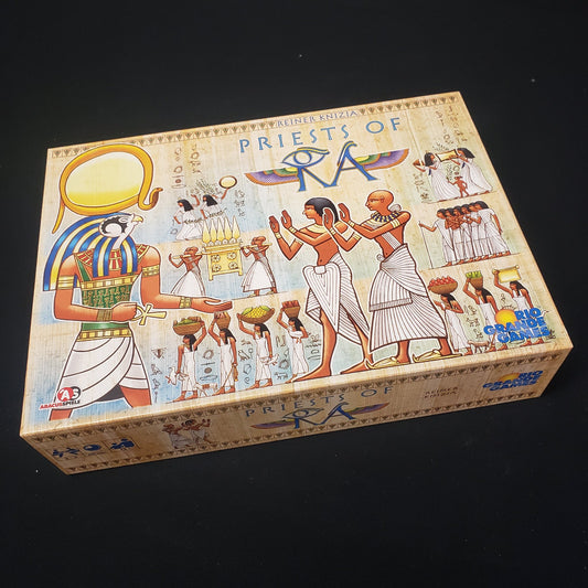 Image shows the front cover of the box of the Priests of RA board game