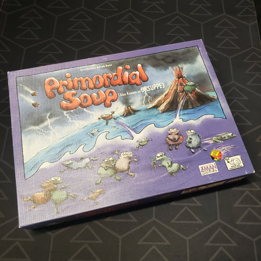 Image shows the front cover of the box for the Primordial Soup board game