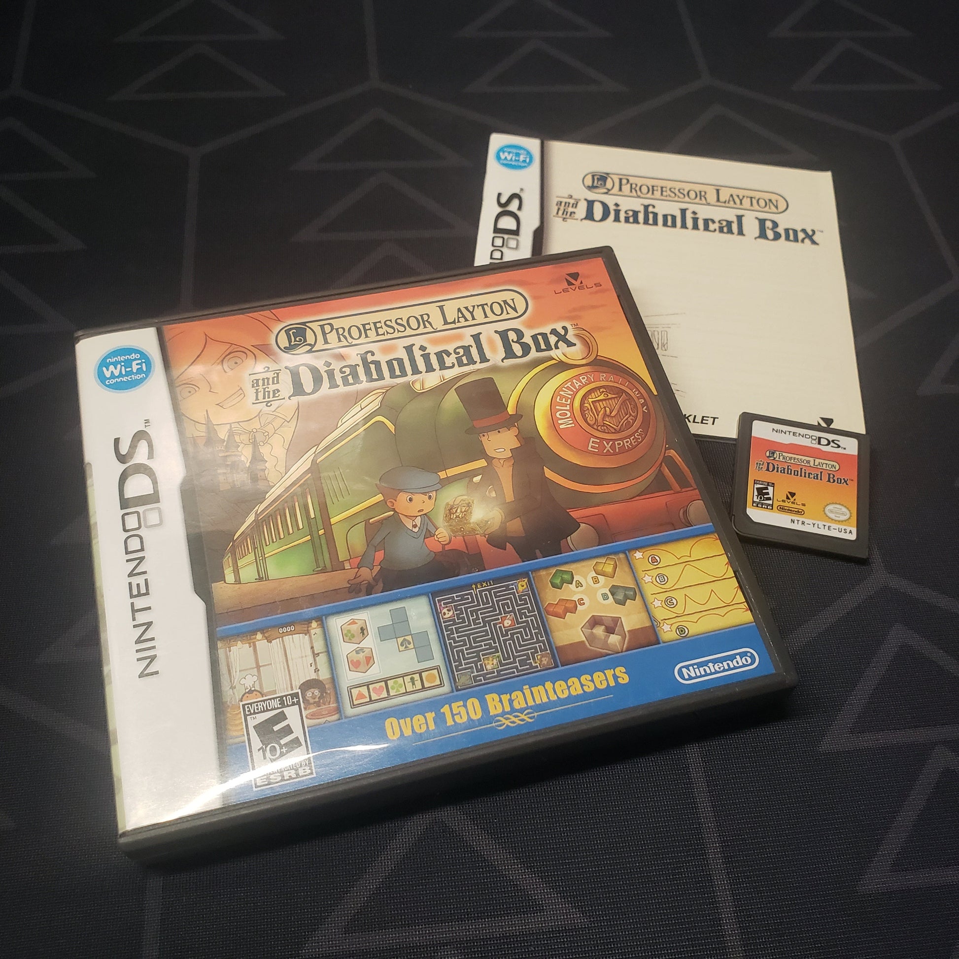 Image shows the case, manual and cartridge for the video game Professor Layton and the Diabolical Box for Nintendo DS