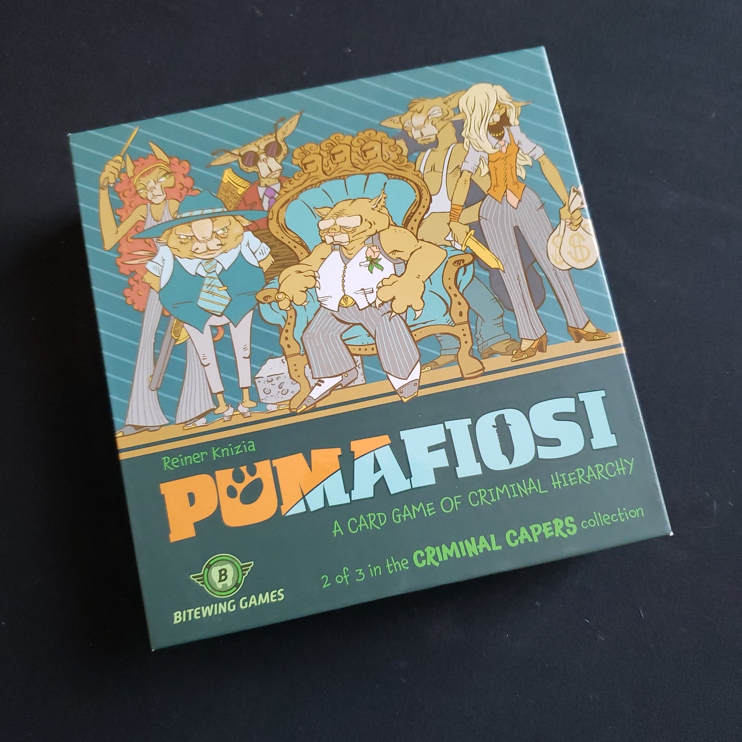 Image shows the front cover of the box of the Pumafiosi card game