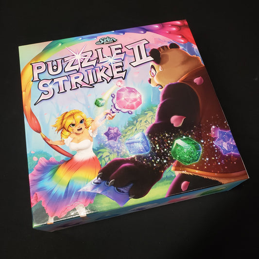 Image shows the front cover of the box of the Puzzle Strike II board game
