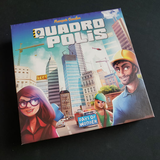 Image shows the front cover of the box of the Quadropolis board game