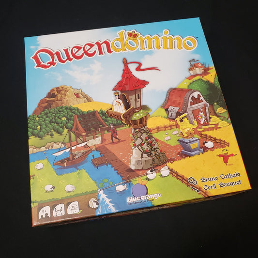 Image shows the front cover of the box of the Queendomino board game