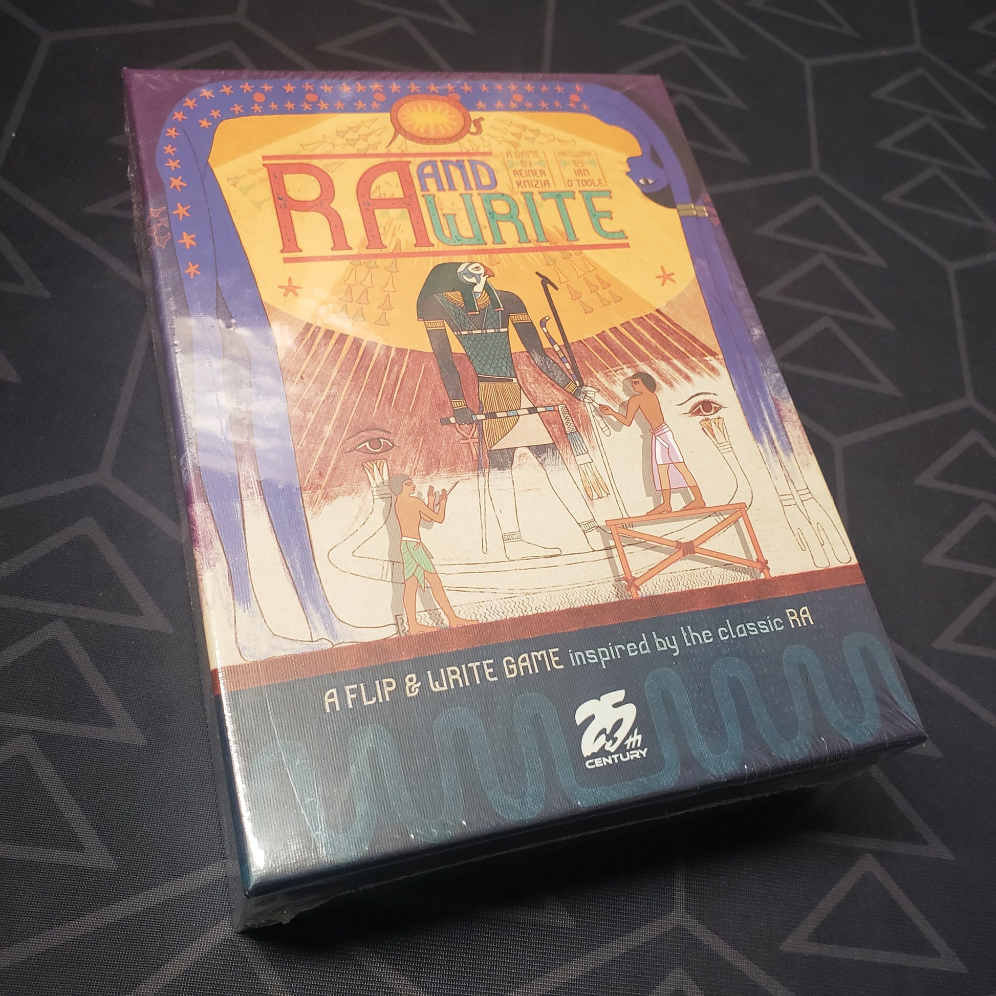 Image shows the front cover of the box for the RA and Write board game