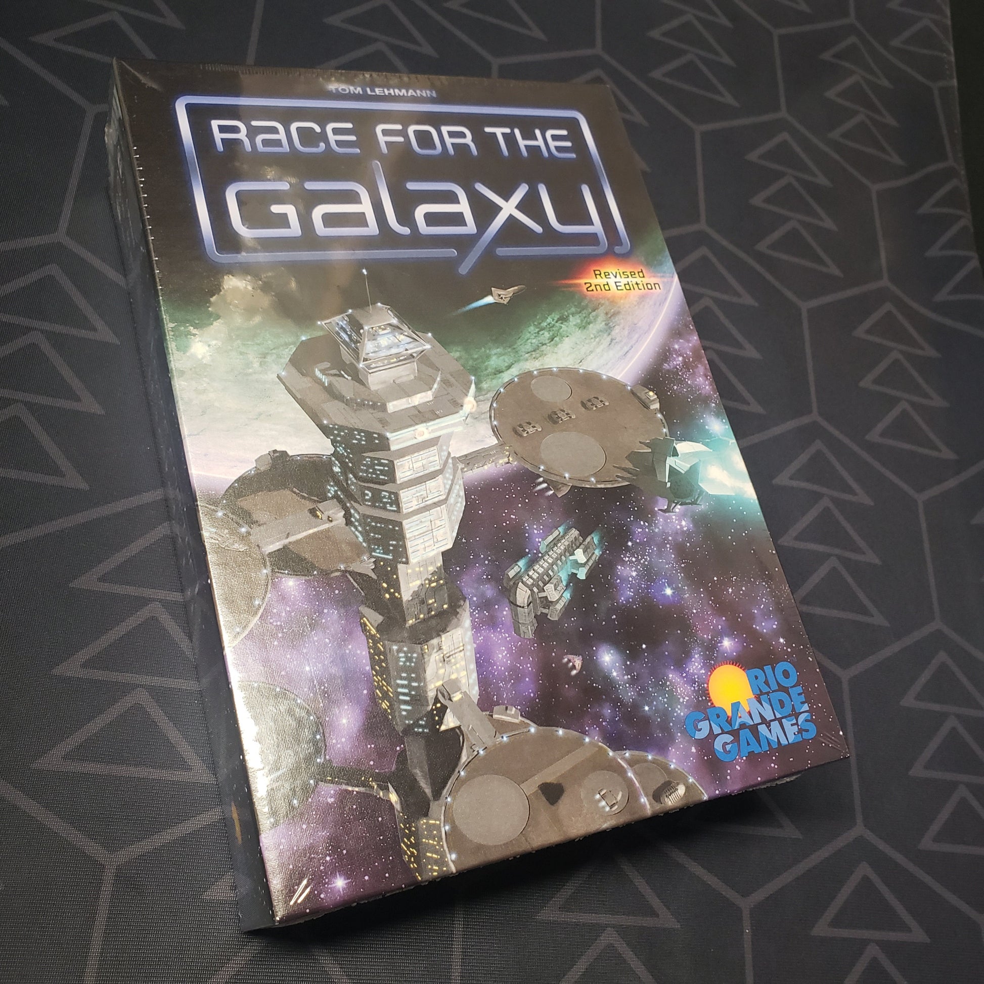 Image shows the front cover of the box for the Race for the Galaxy (Revised Second Edition) board game
