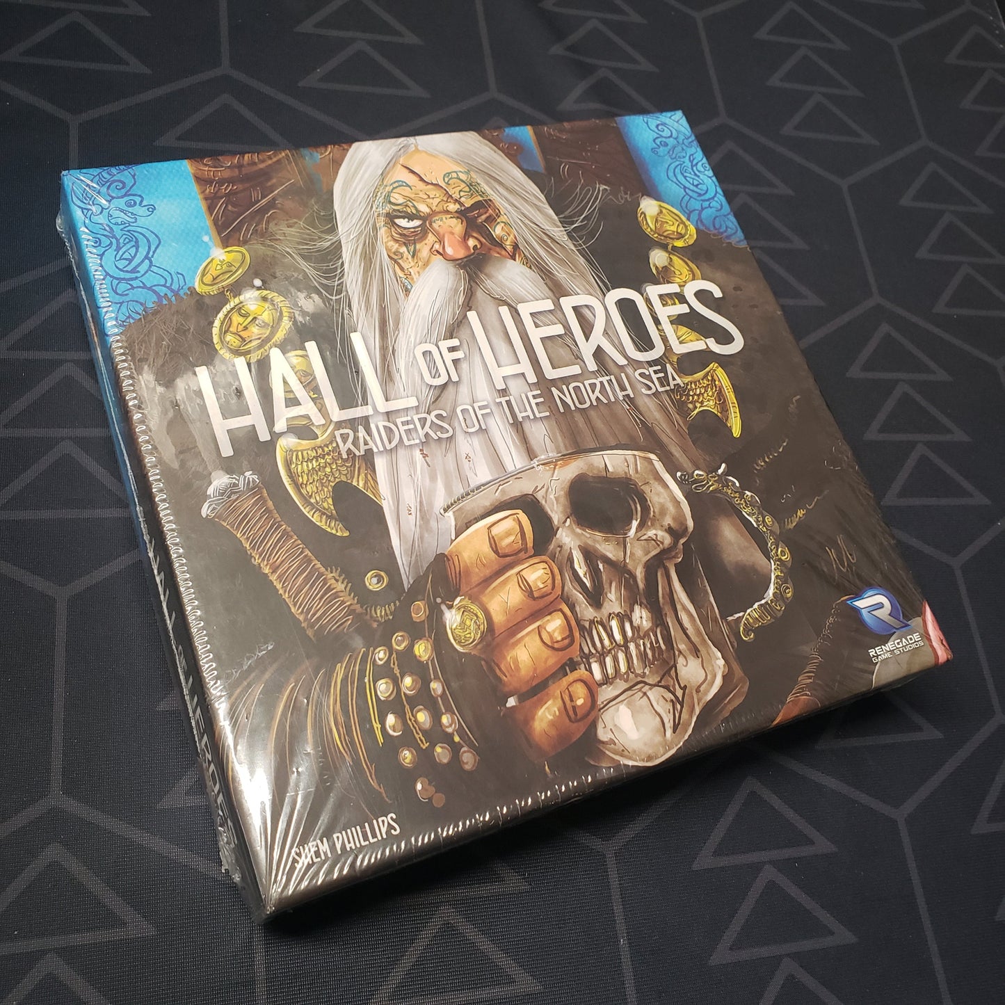 Image shows the front cover of the box of the Hall of Heroes expansion for the board game Raiders of the North Sea