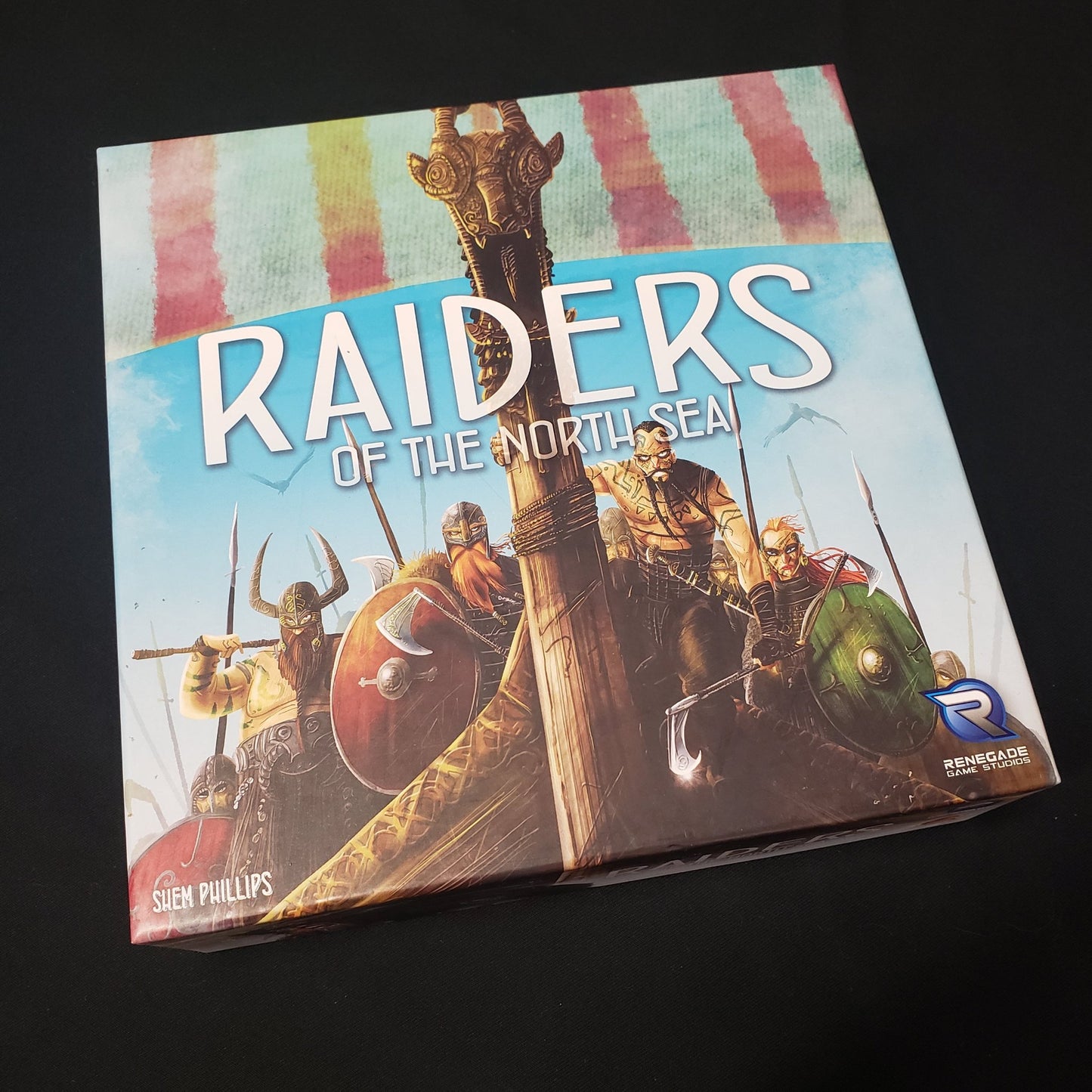Image shows the front cover of the box of the Raiders of the North Sea board game