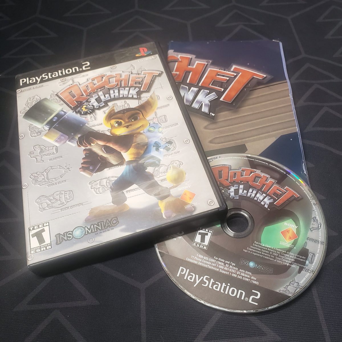 Image shows the case, poster and disc for the video game Ratchet & Clank for Playstation 2
