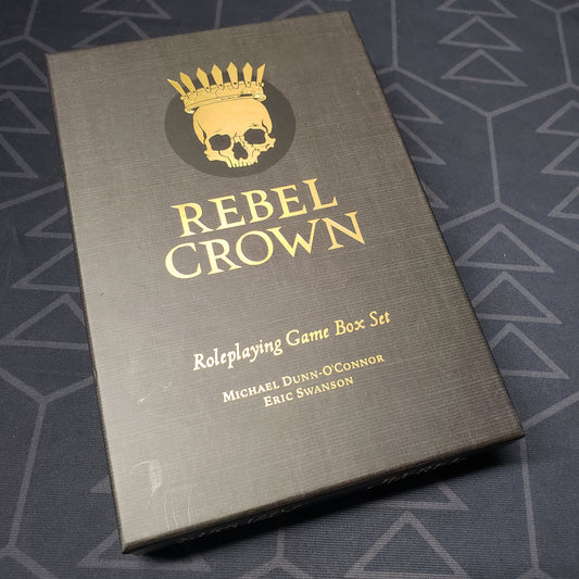 Image shows the front cover of the box set for the roleplaying game Rebel Crown
