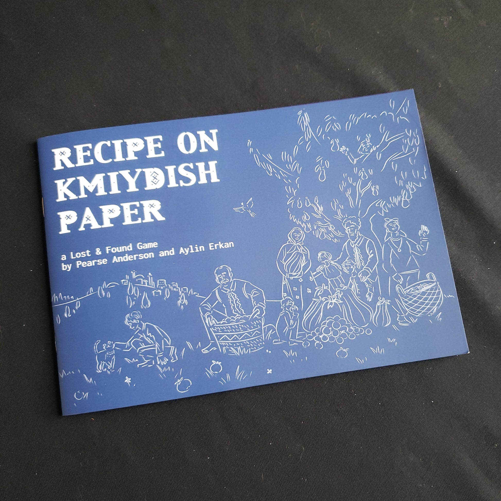 Image shows the front cover of the Recipe on Kmiydish Paper roleplaying game book