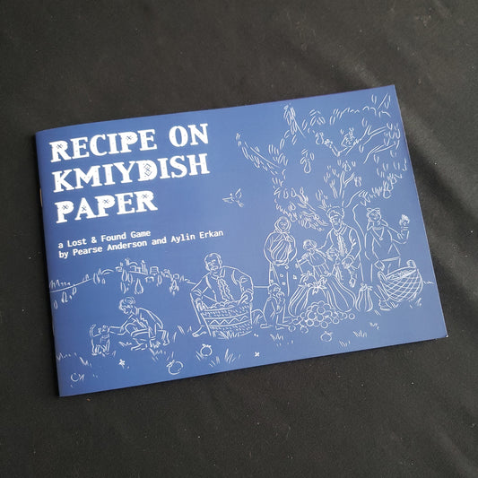 Image shows the front cover of the Recipe on Kmiydish Paper roleplaying game book