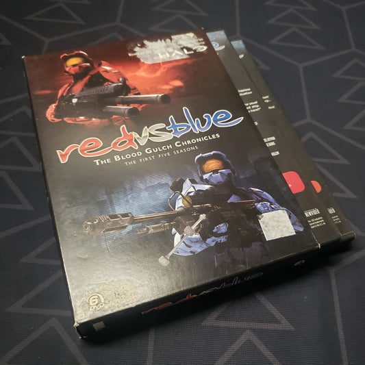 Image shows the outer box & two fanned-out disc cases for the seasons 1-5 box set of Red vs. Blue on DVD