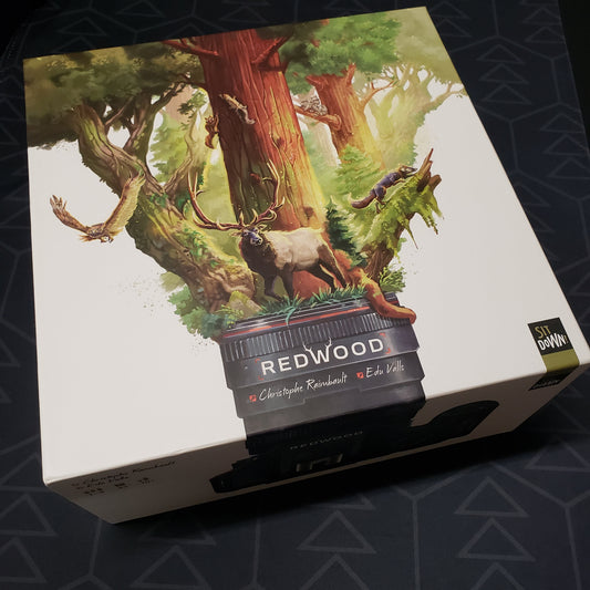 Image shows the front cover of the box of the Kickstarter Edition of the board game Redwood