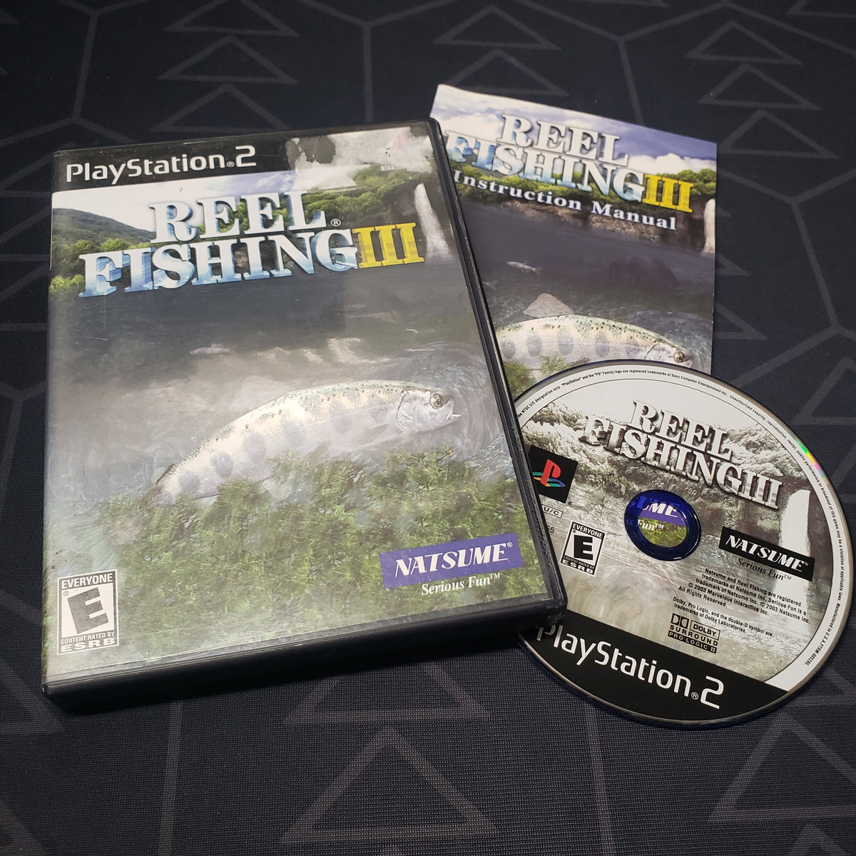 Image shows the case, manual and disc for the video game Reel Fishing III for Playstation 2